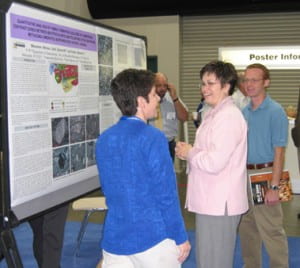 Melissa (in pink) presenting her poster at GSA in Salt Lake City.